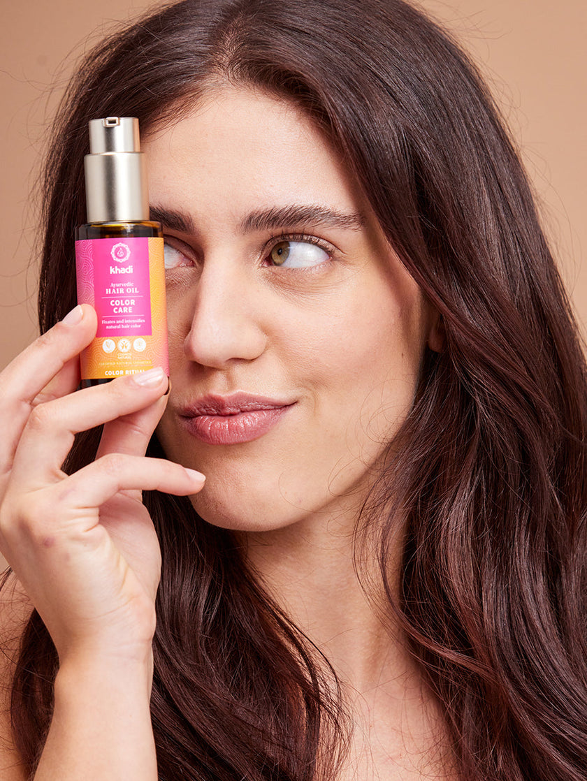 A model presenting khadi natural hair oil